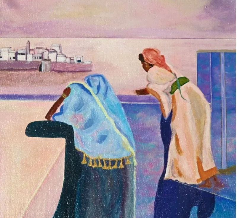 Two women in headscarves on a balcony overlooking the sea